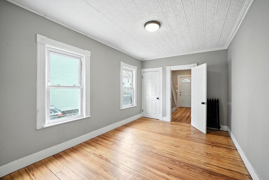 30 Beauchamp Street Springfield, MA 01107 - Photo 5 of 30 an empty room with wooden floor and windows