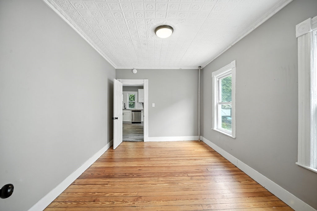 30 Beauchamp Street Springfield, MA 01107 - Photo 6 of 30 a view of an empty room with wooden floor and a window