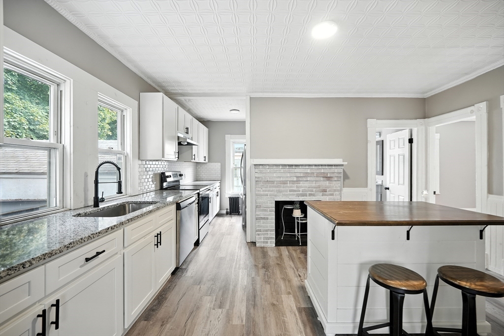 30 Beauchamp Street Springfield, MA 01107 - Photo 8 of 30 a kitchen with granite countertop white cabinets and appliances