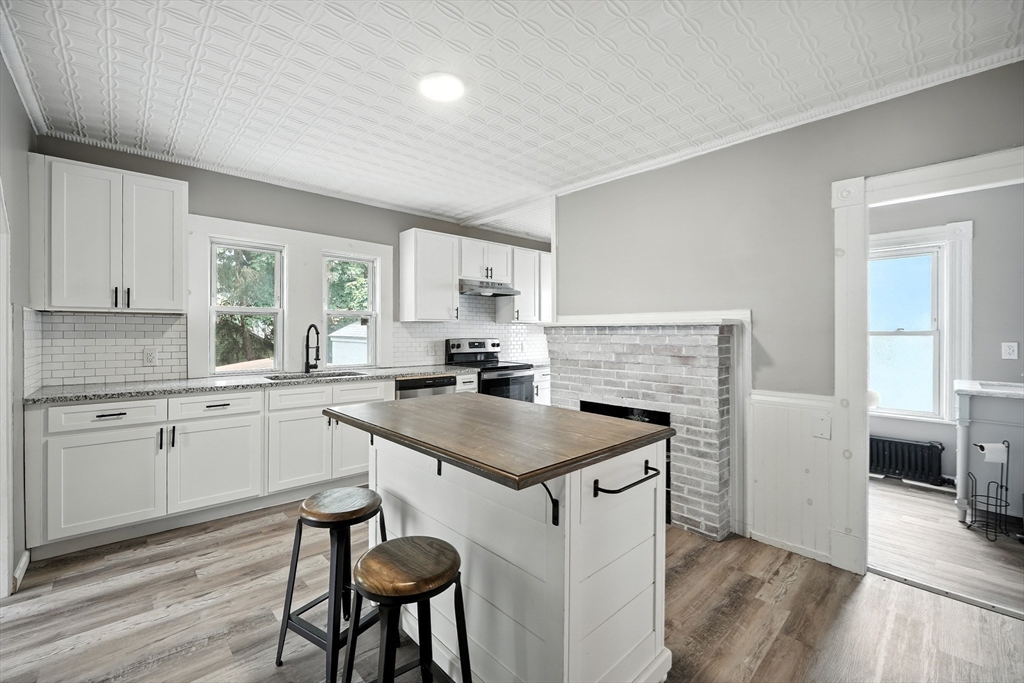 30 Beauchamp Street Springfield, MA 01107 - Photo 9 of 30 a kitchen with a stove a sink and a refrigerator