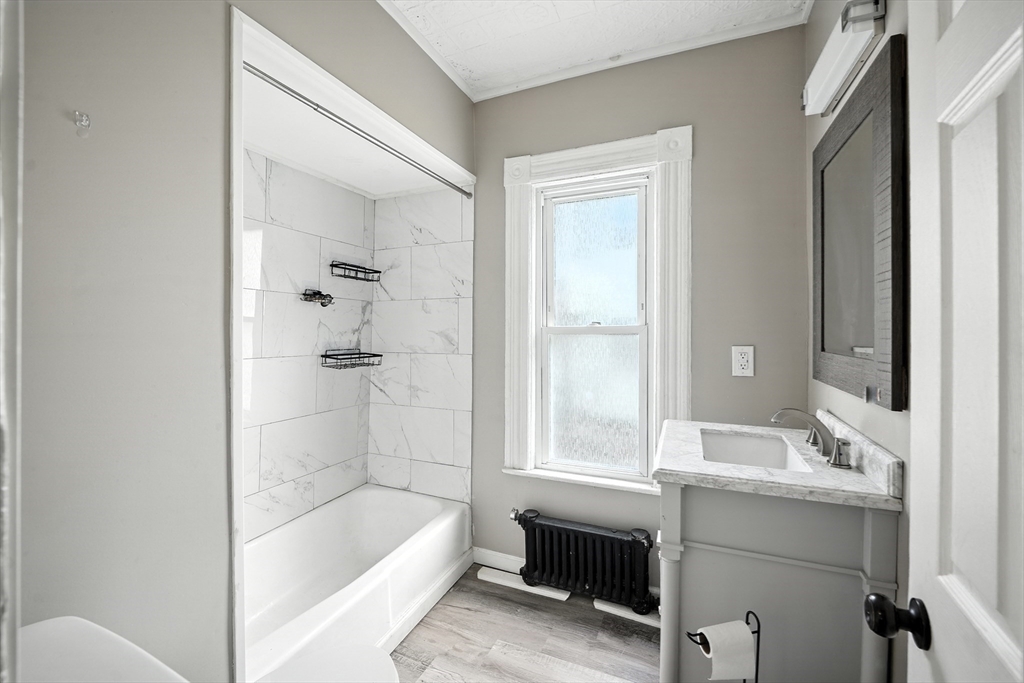 30 Beauchamp Street Springfield, MA 01107 - Photo 10 of 30 a bathroom with a bathtub sink and toilet