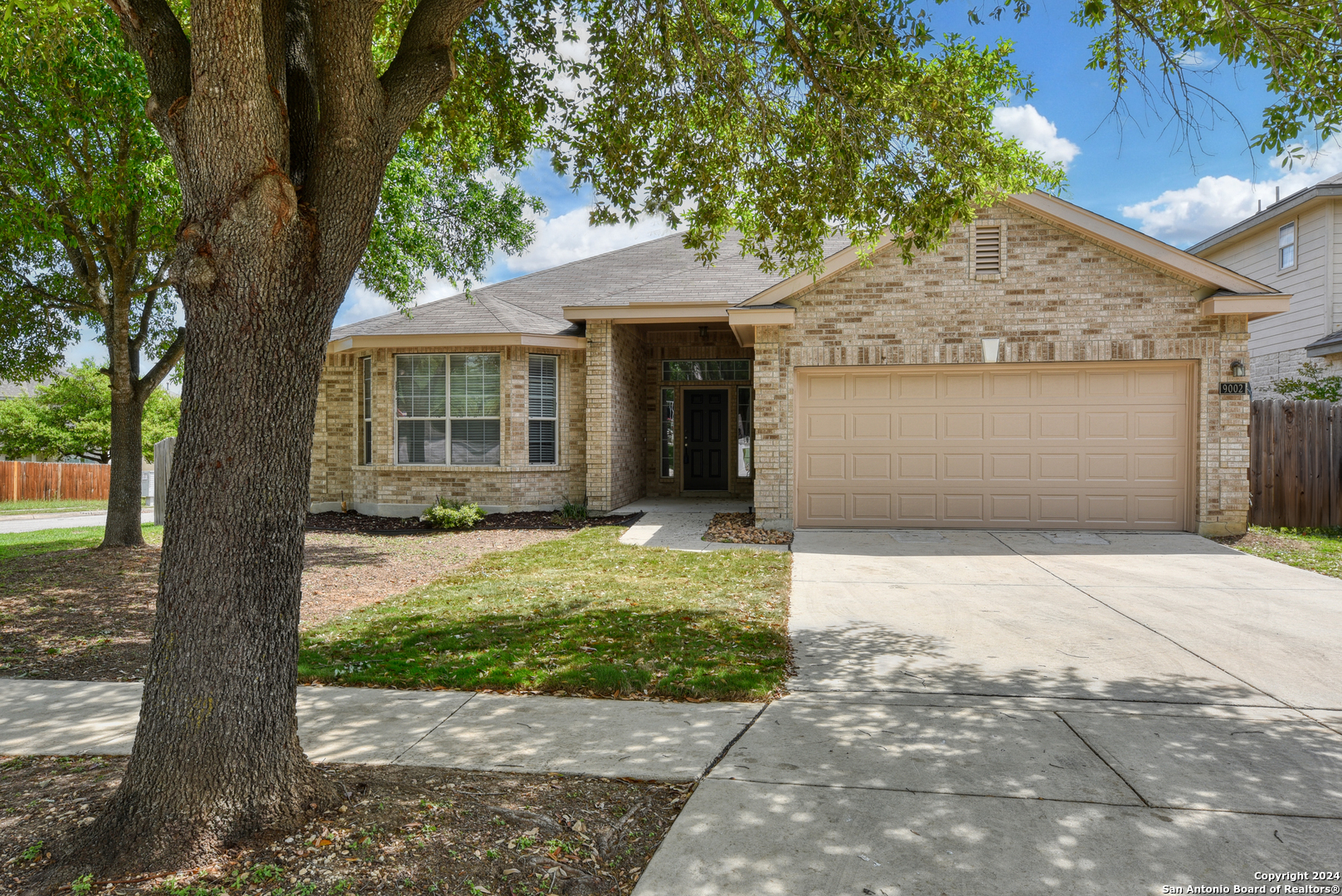 9002 Eagle Bend Helotes, TX 78023 - Photo 1 of 1 a front view of a house with a garden and trees