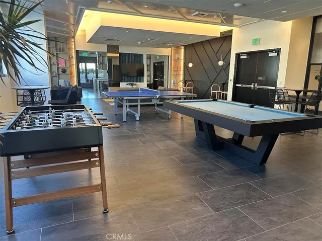 a living room with furniture a flat screen tv and large window