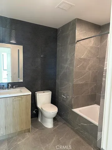 a bathroom with a toilet a sink and a bathtub