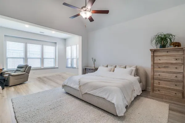 a bedroom with a large bed and a couch