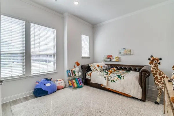 a bedroom with furniture and a window
