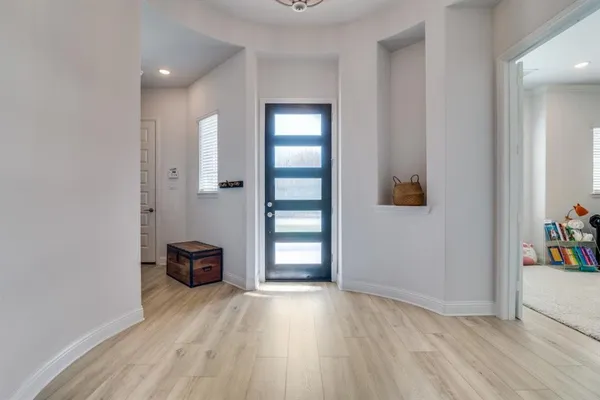 an empty room with wooden floor and closet