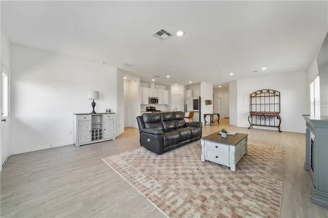 a living room with furniture and kitchen view