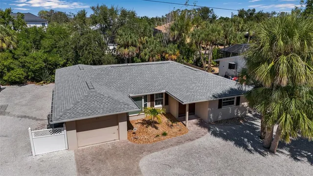 an aerial view of a house with swimming pool and sitting area