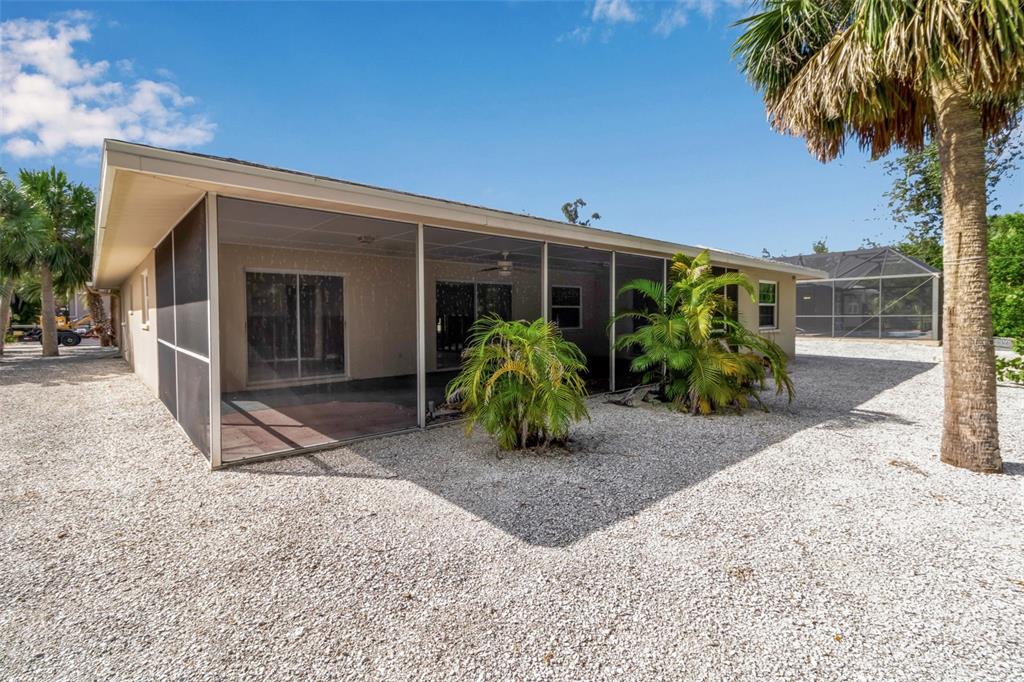 315 Avenida De Paradisio Sarasota, FL 34242 - Photo 20 of 27 a view of a house with potted plants and a large tree