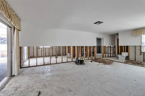 a view of a livingroom with entryway and furniture