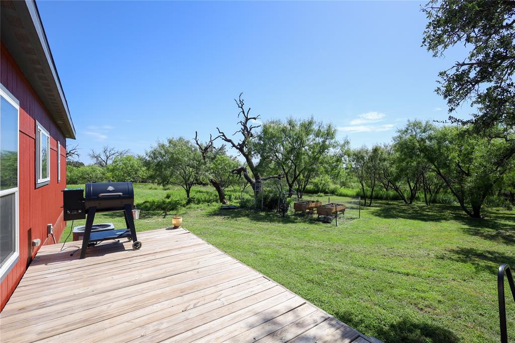 55 County Road West Comanche, TX 76442 - Photo 13 of 38 a view of a chair and table on the wooden deck