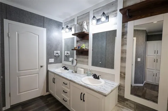 a bathroom with a double vanity sink and mirror