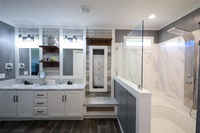 a bathroom with a sink double vanity and a mirror