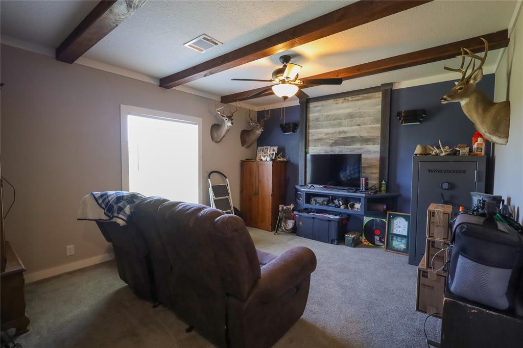 55 County Road West Comanche, TX 76442 - Photo 29 of 38 a living room with furniture and a flat screen tv