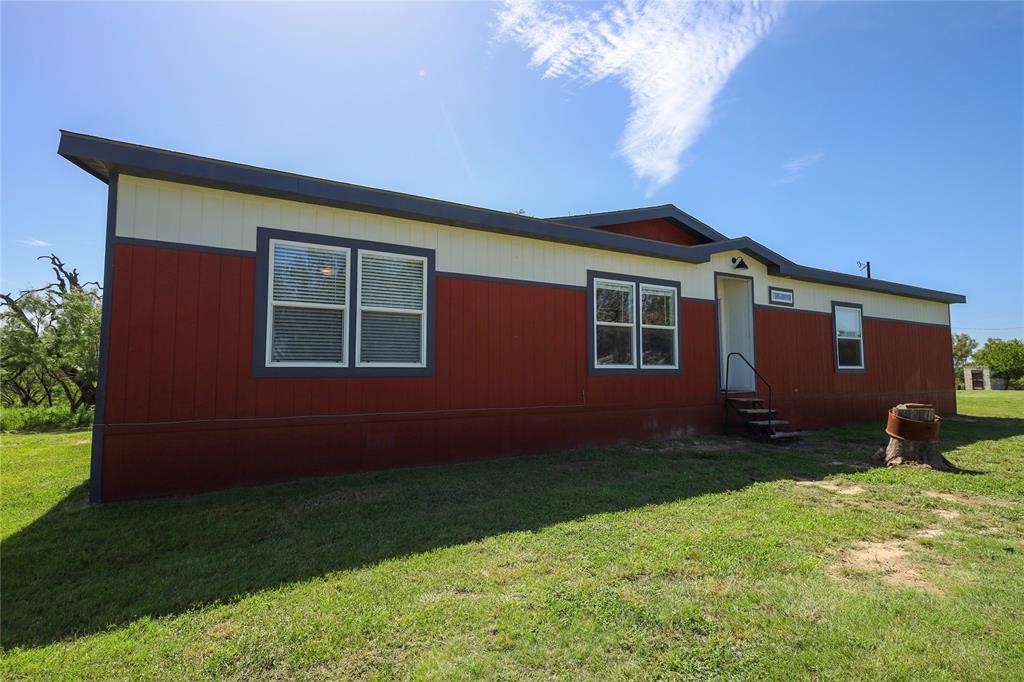 55 County Road West Comanche, TX 76442 - Photo 8 of 37 View of side of property with entry steps and a yard very nice like new double wide