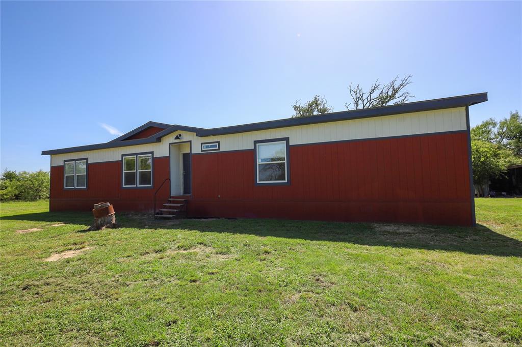 55 County Road West Comanche, TX 76442 - Photo 9 of 37 View of front facade featuring entry steps and a front lawn nice like new double wide