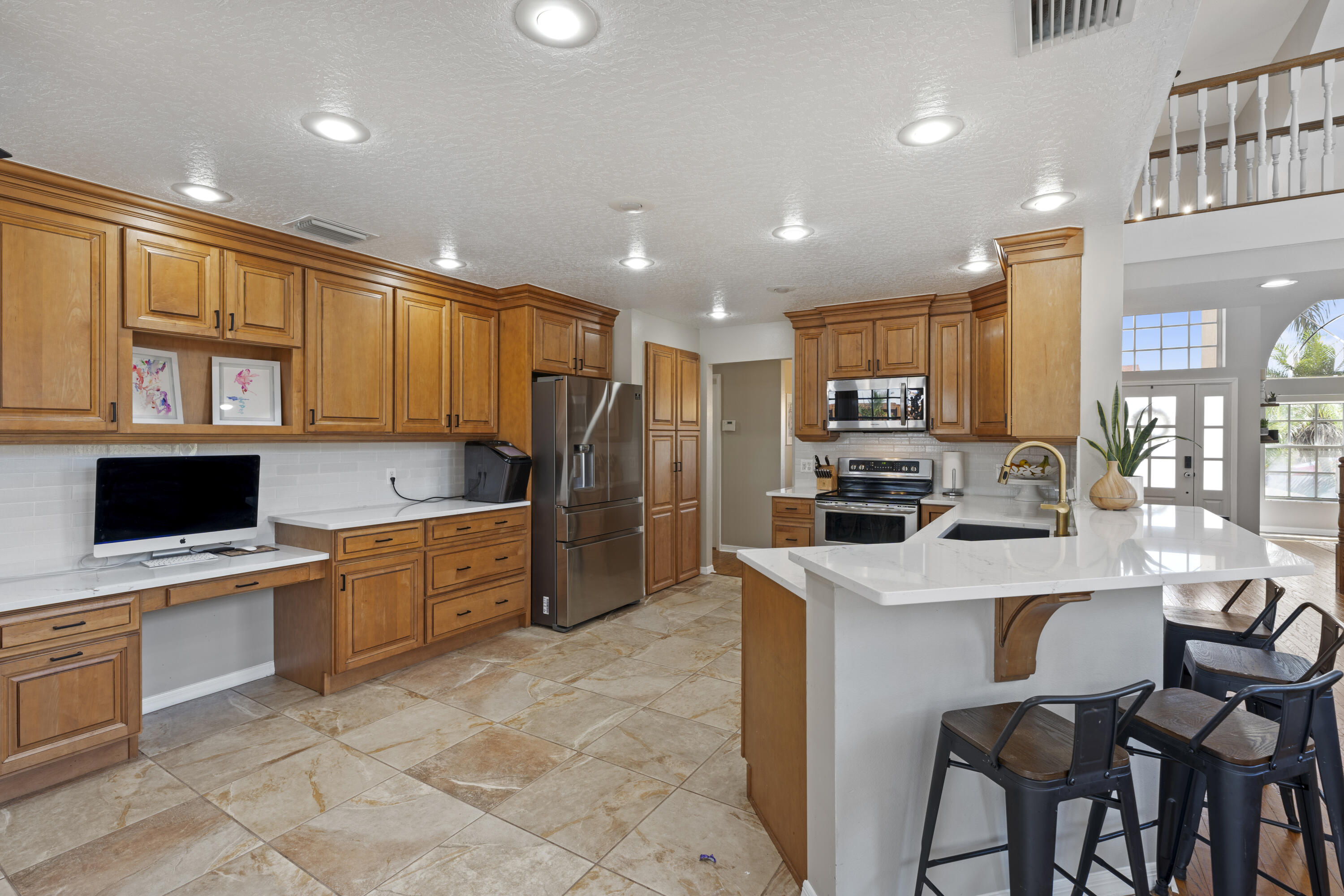 2639 Lowell Circle Melbourne, FL 32935 - Photo 14 of 46 a kitchen with stainless steel appliances granite countertop a stove top oven a sink dishwasher a stove and a refrigerator with island