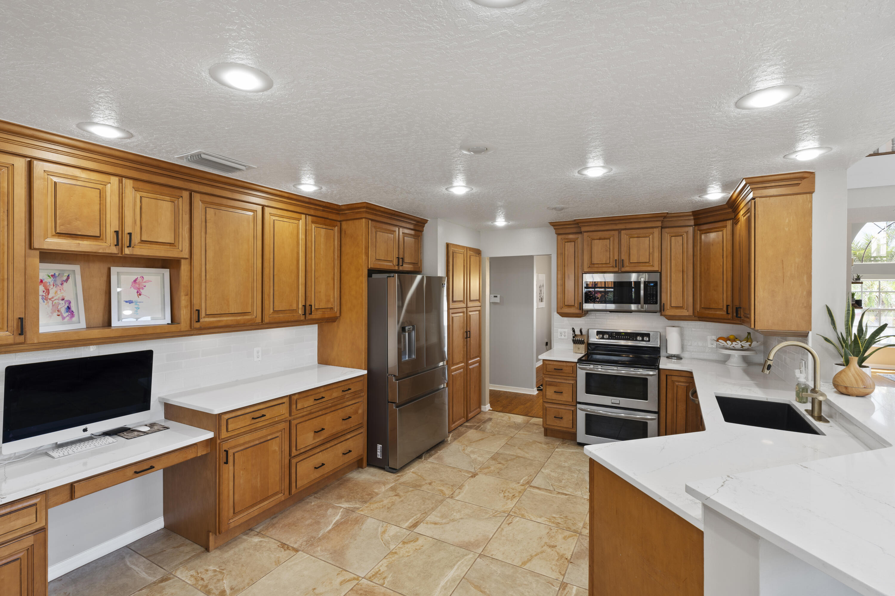 2639 Lowell Circle Melbourne, FL 32935 - Photo 15 of 46 a kitchen with stainless steel appliances a stove a refrigerator and a sink