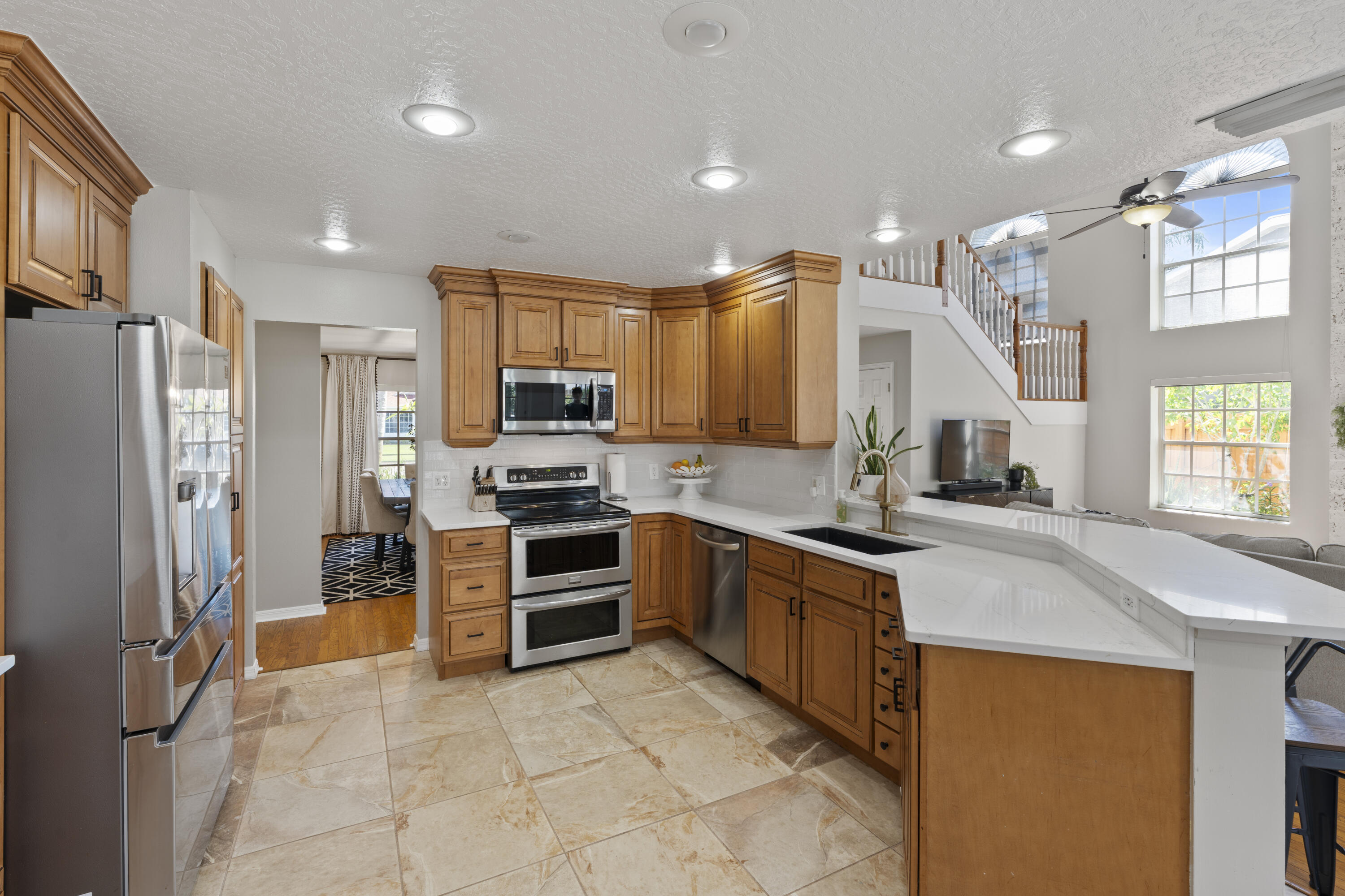 2639 Lowell Circle Melbourne, FL 32935 - Photo 16 of 46 a kitchen with stainless steel appliances granite countertop a refrigerator and a sink