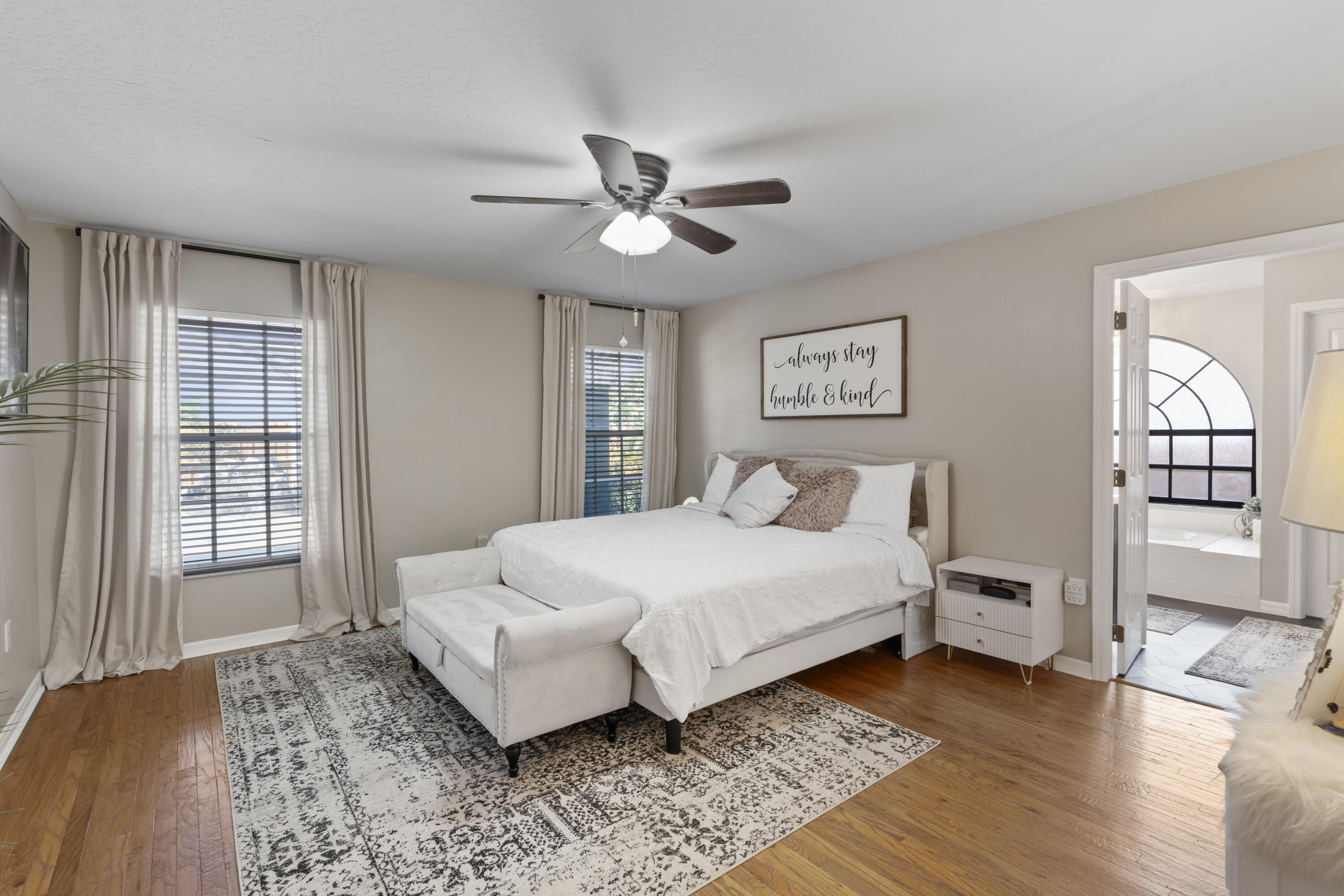 2639 Lowell Circle Melbourne, FL 32935 - Photo 19 of 46 a spacious bedroom with a bed and wooden floor