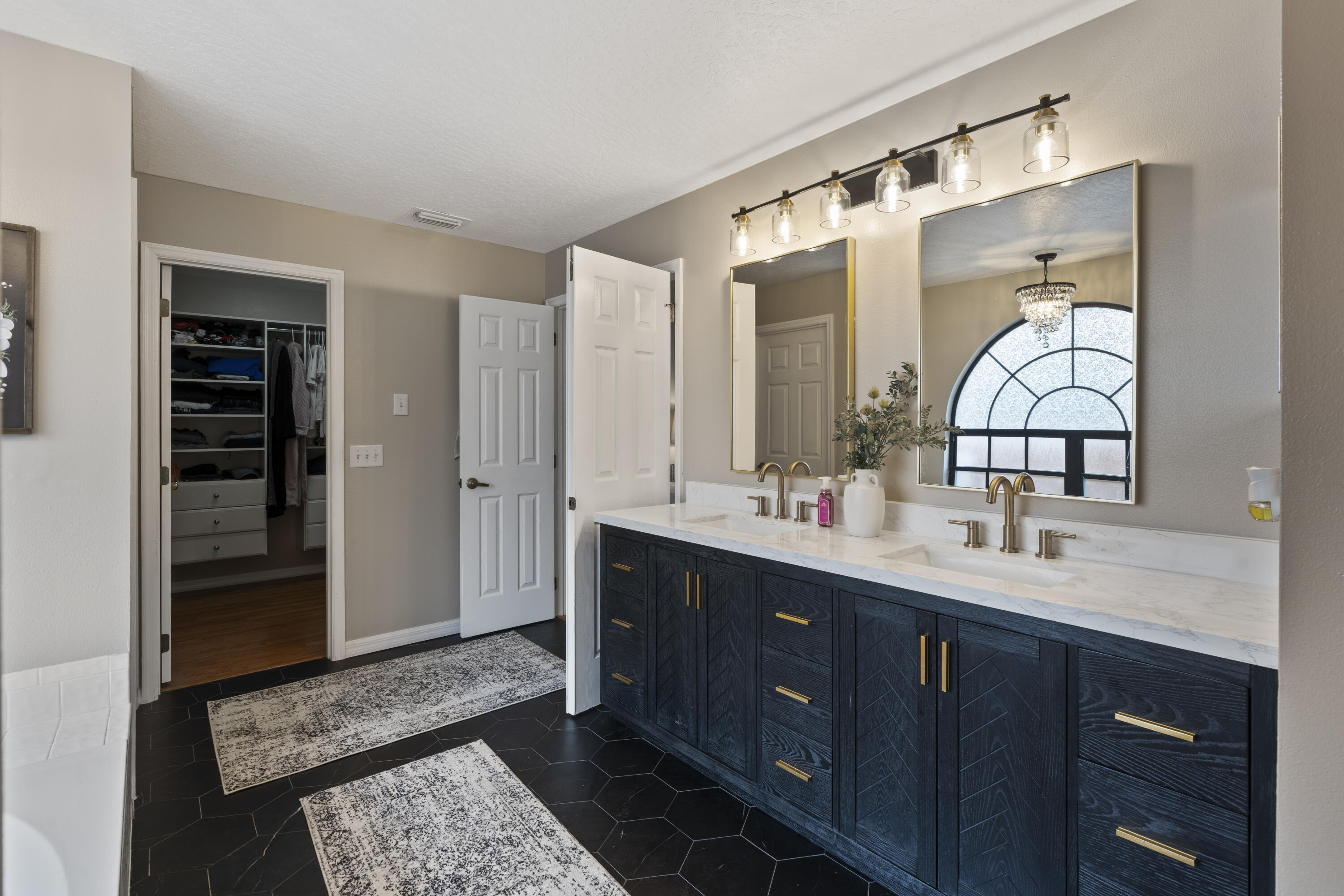 2639 Lowell Circle Melbourne, FL 32935 - Photo 21 of 46 a bathroom with a double vanity sink and a mirror