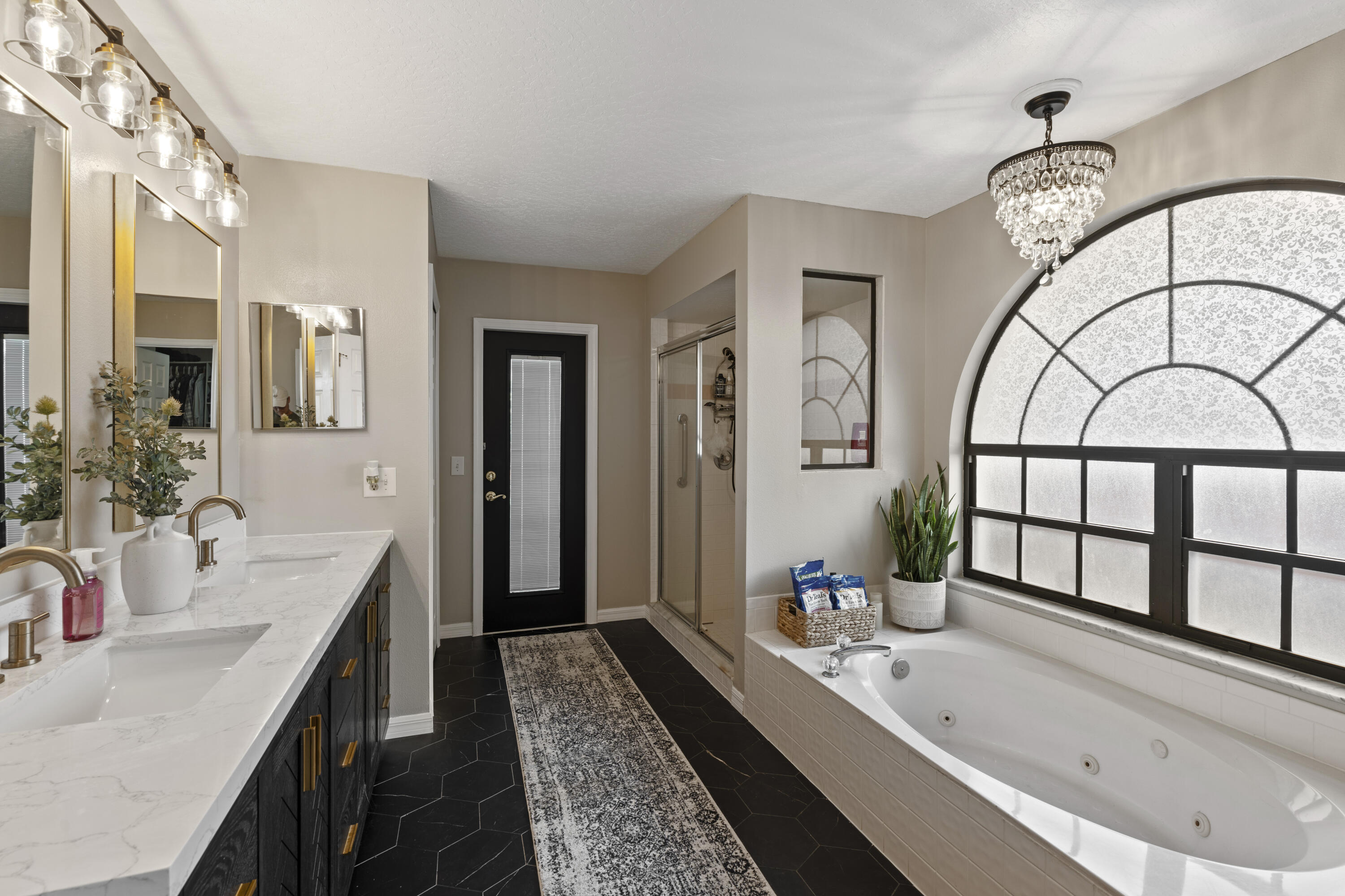 2639 Lowell Circle Melbourne, FL 32935 - Photo 22 of 46 a bathroom with a granite countertop tub a sink and a large mirror