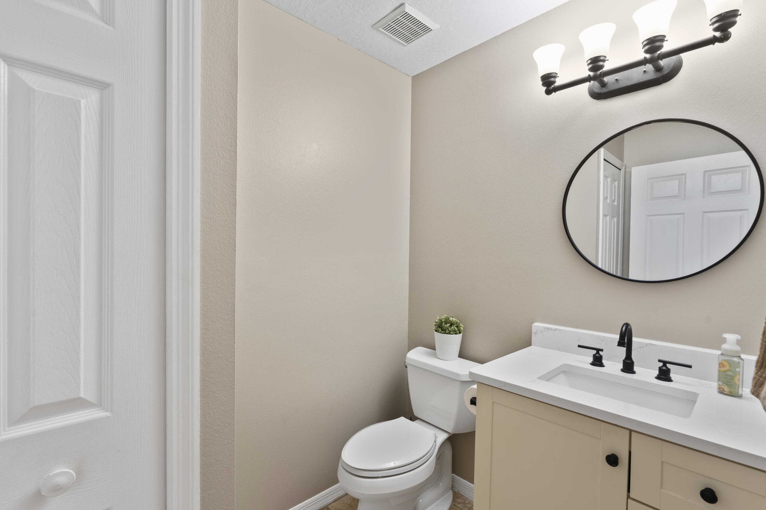 2639 Lowell Circle Melbourne, FL 32935 - Photo 25 of 46 a bathroom with a sink a toilet and a mirror