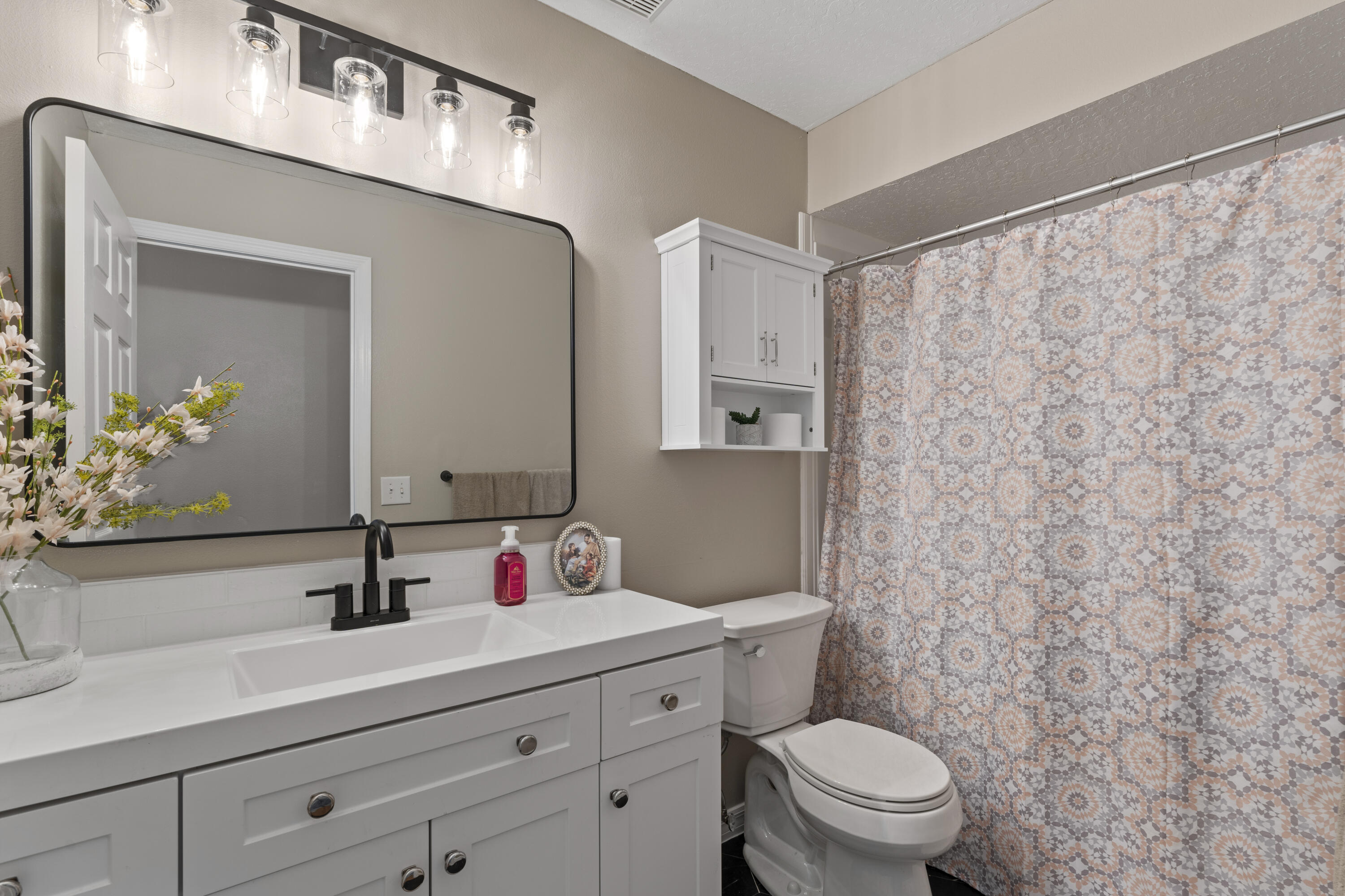 2639 Lowell Circle Melbourne, FL 32935 - Photo 31 of 46 a bathroom with a sink a toilet and a mirror