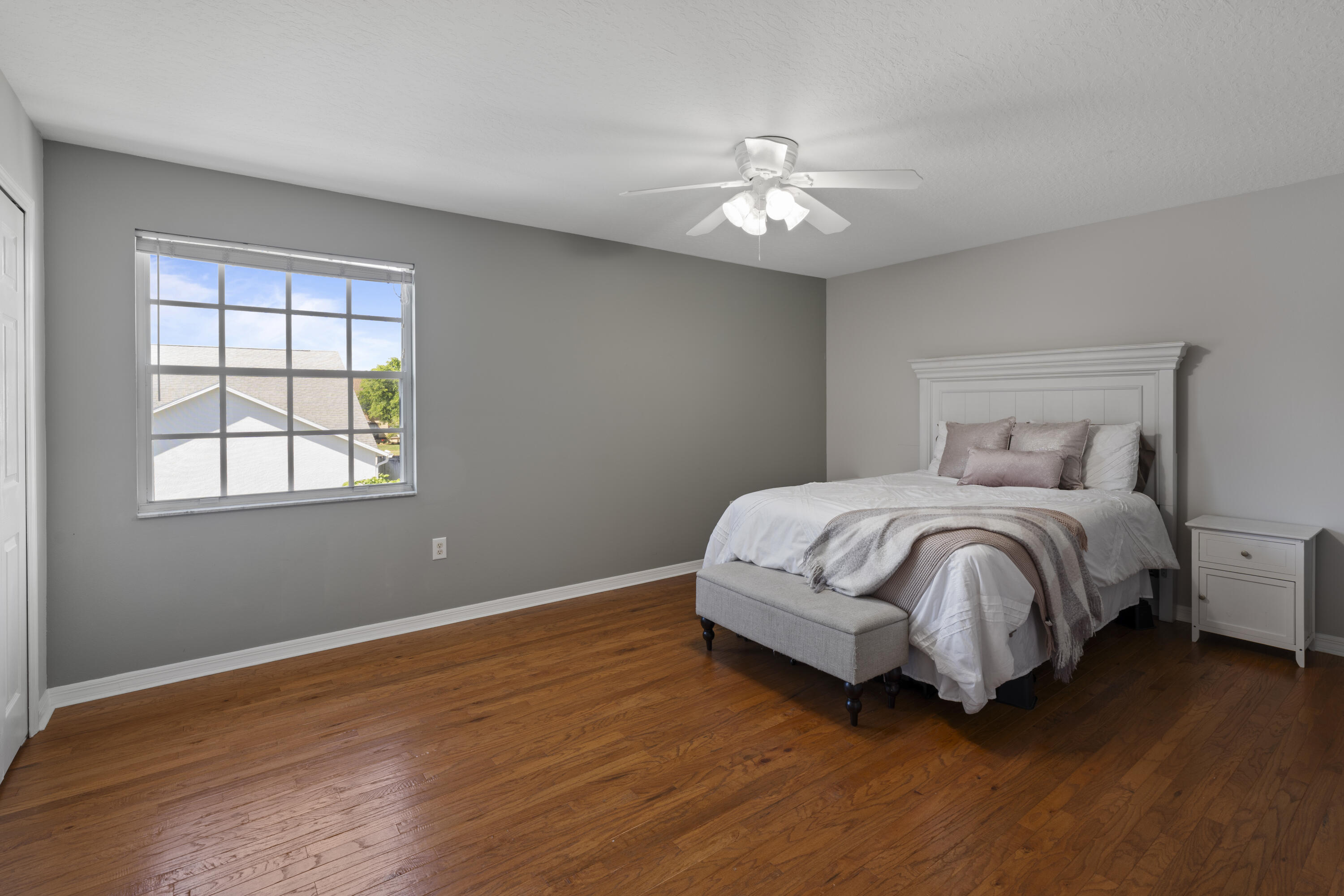 2639 Lowell Circle Melbourne, FL 32935 - Photo 32 of 46 a bedroom with a bed and a chandelier