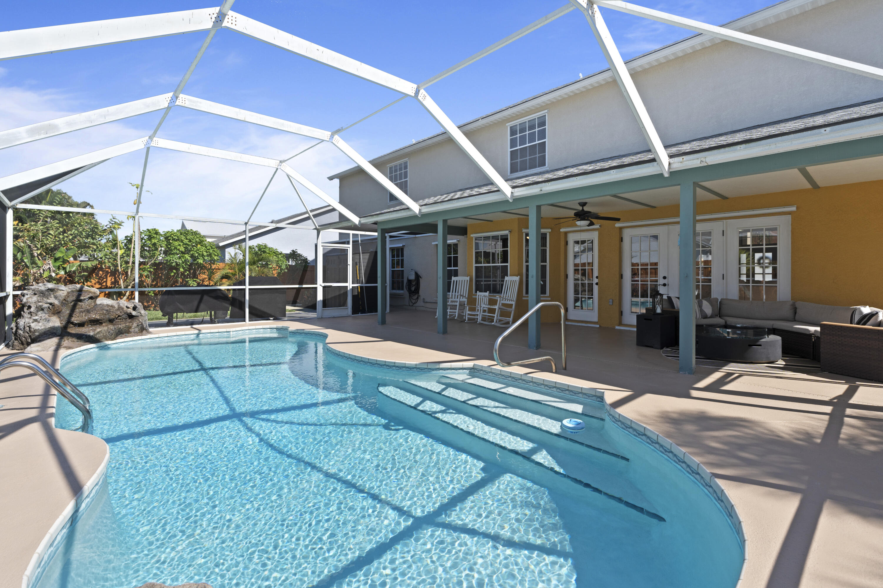 2639 Lowell Circle Melbourne, FL 32935 - Photo 39 of 46 a view of a patio with table and chairs under an umbrella