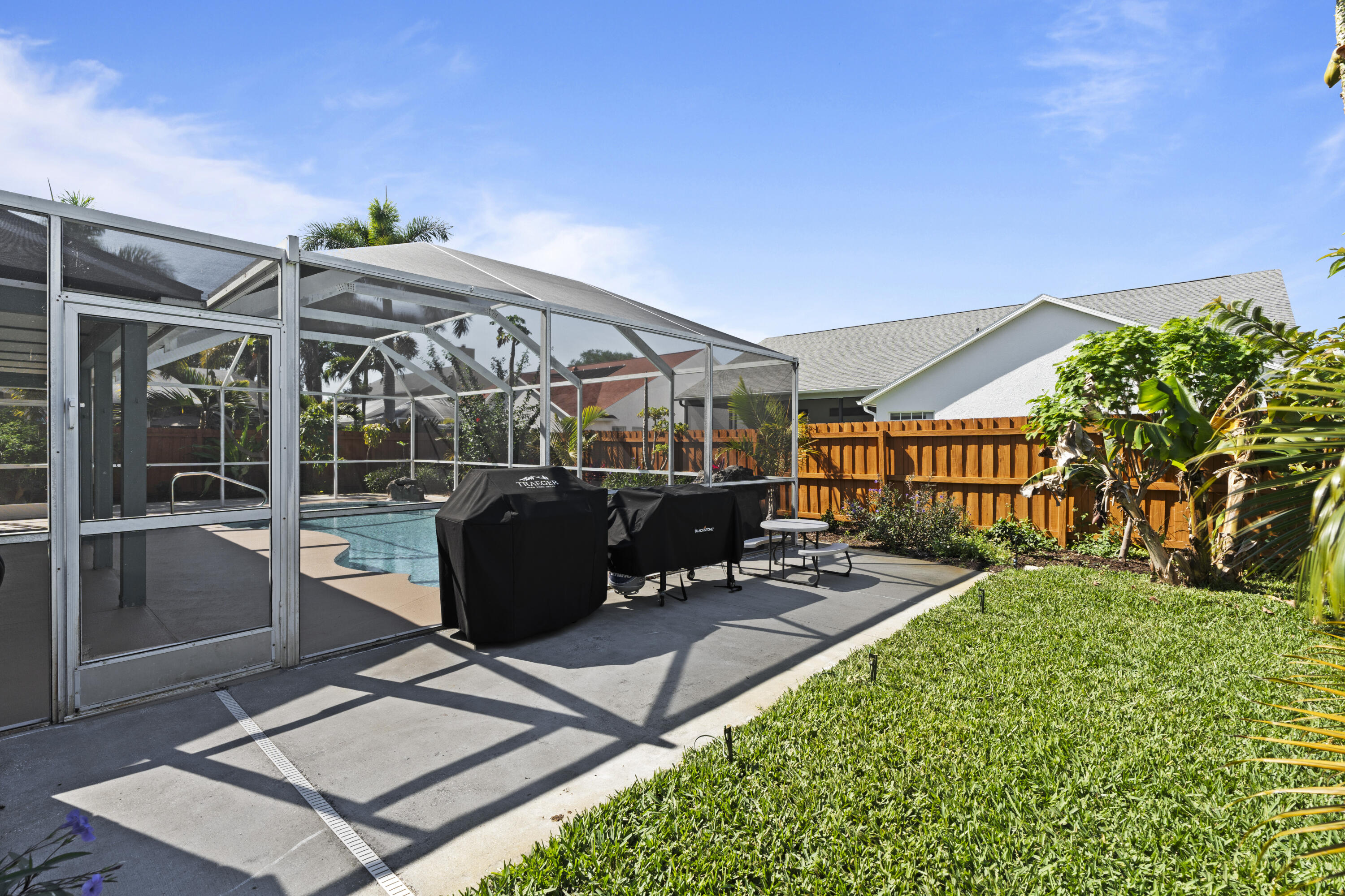 2639 Lowell Circle Melbourne, FL 32935 - Photo 41 of 46 a view of a patio with table and chairs potted plants with wooden floor and fence