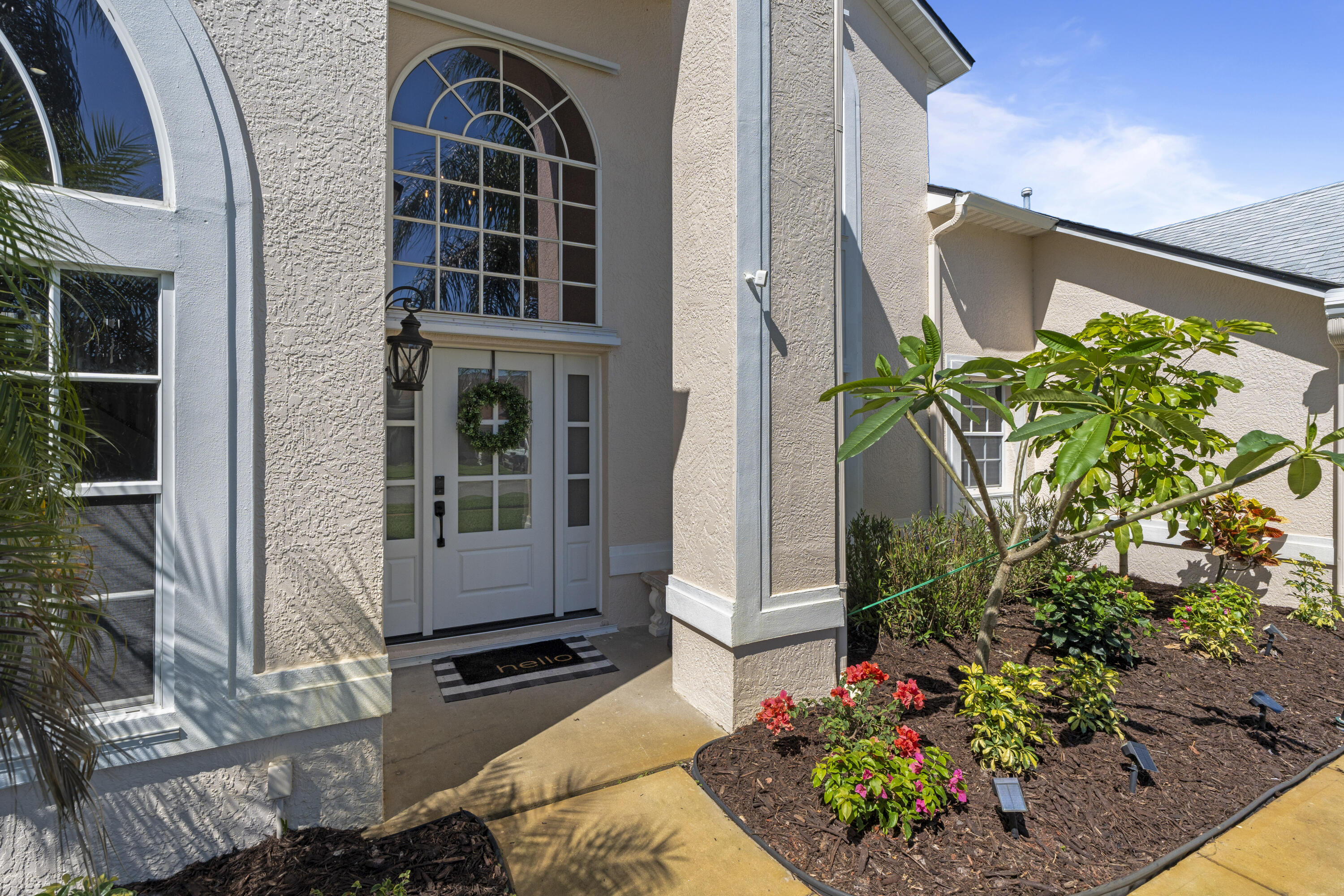 2639 Lowell Circle Melbourne, FL 32935 - Photo 44 of 46 a front view of a house with a garden