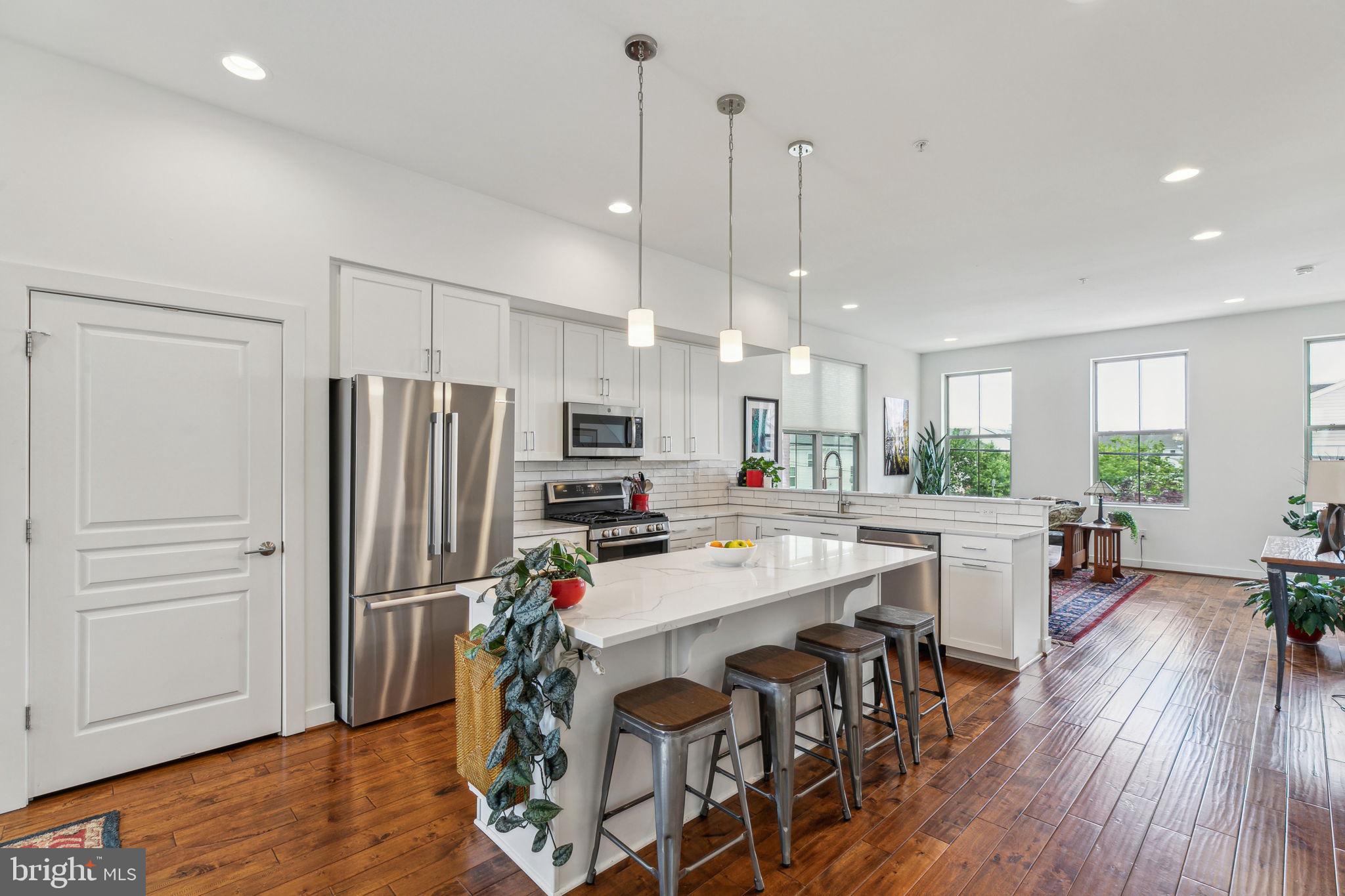 410 Reed Street Philadelphia, PA 19147 - Photo 1 of 39 a kitchen with stainless steel appliances a dining table chairs stove refrigerator and cabinets