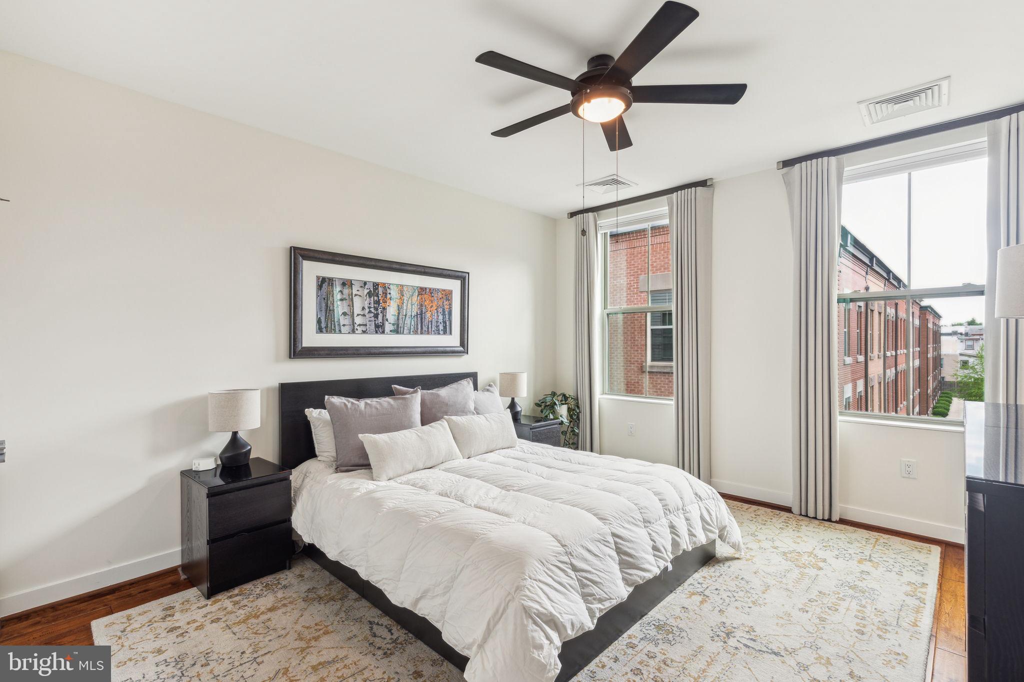 410 Reed Street Philadelphia, PA 19147 - Photo 16 of 39 a bedroom with a large bed with wooden floor next to a window