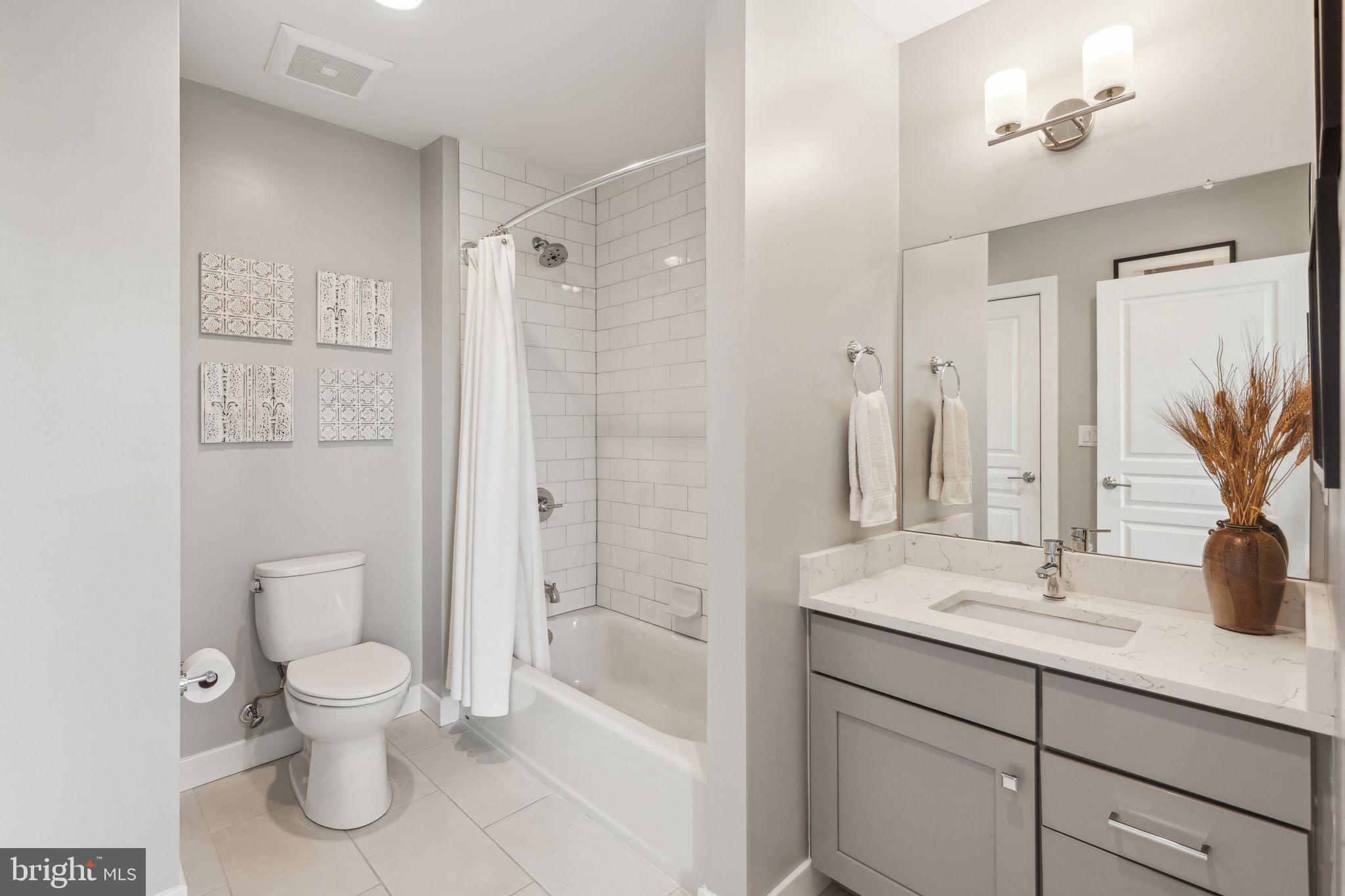 410 Reed Street Philadelphia, PA 19147 - Photo 18 of 39 a bathroom with a toilet a sink a mirror and a shower