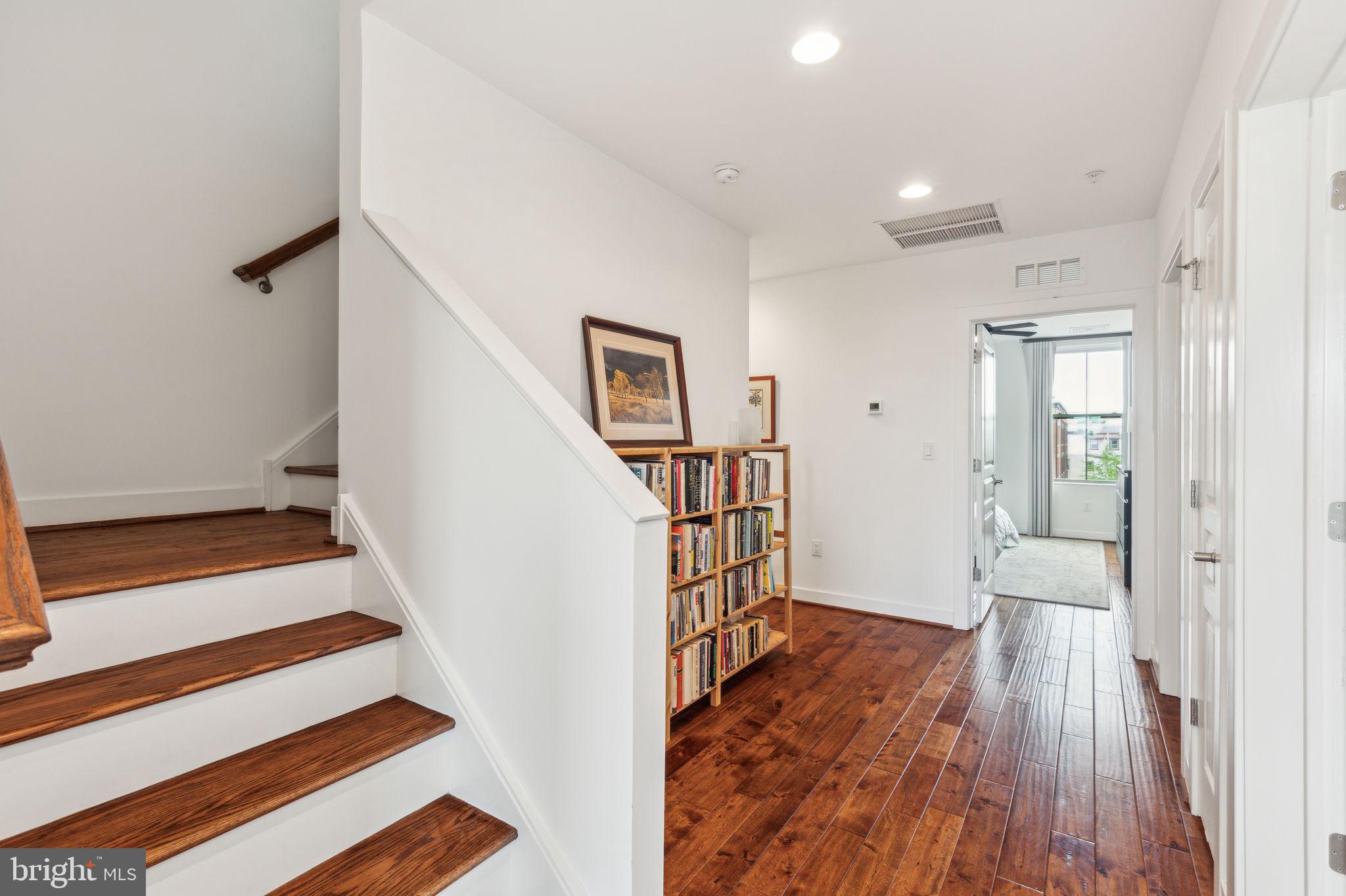 410 Reed Street Philadelphia, PA 19147 - Photo 19 of 39 a view of a hallway with wooden floor and stairs