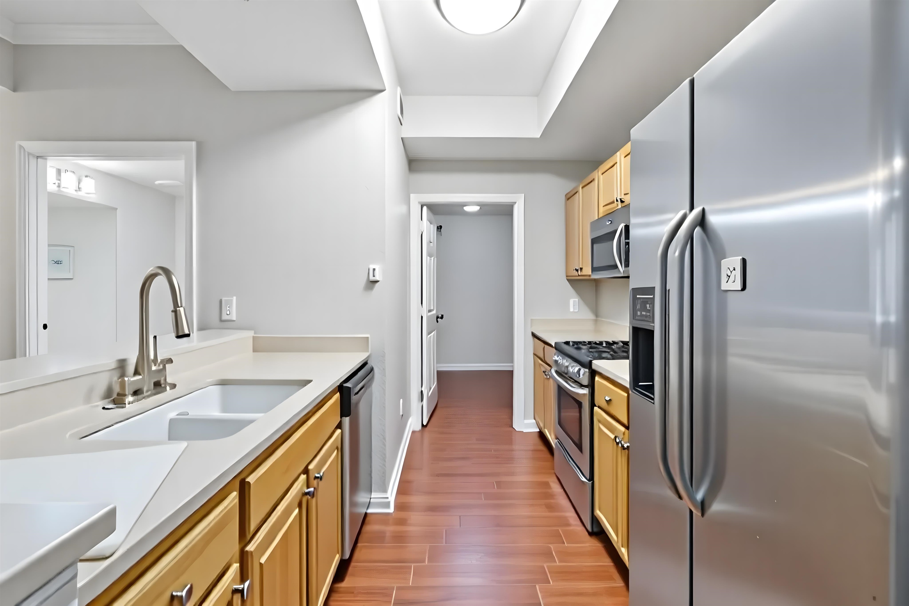 10075 Gate Parkway, Unit 203 Jacksonville, FL 32246 - Photo 19 of 34 a kitchen with kitchen island granite countertop a sink and stainless steel appliances