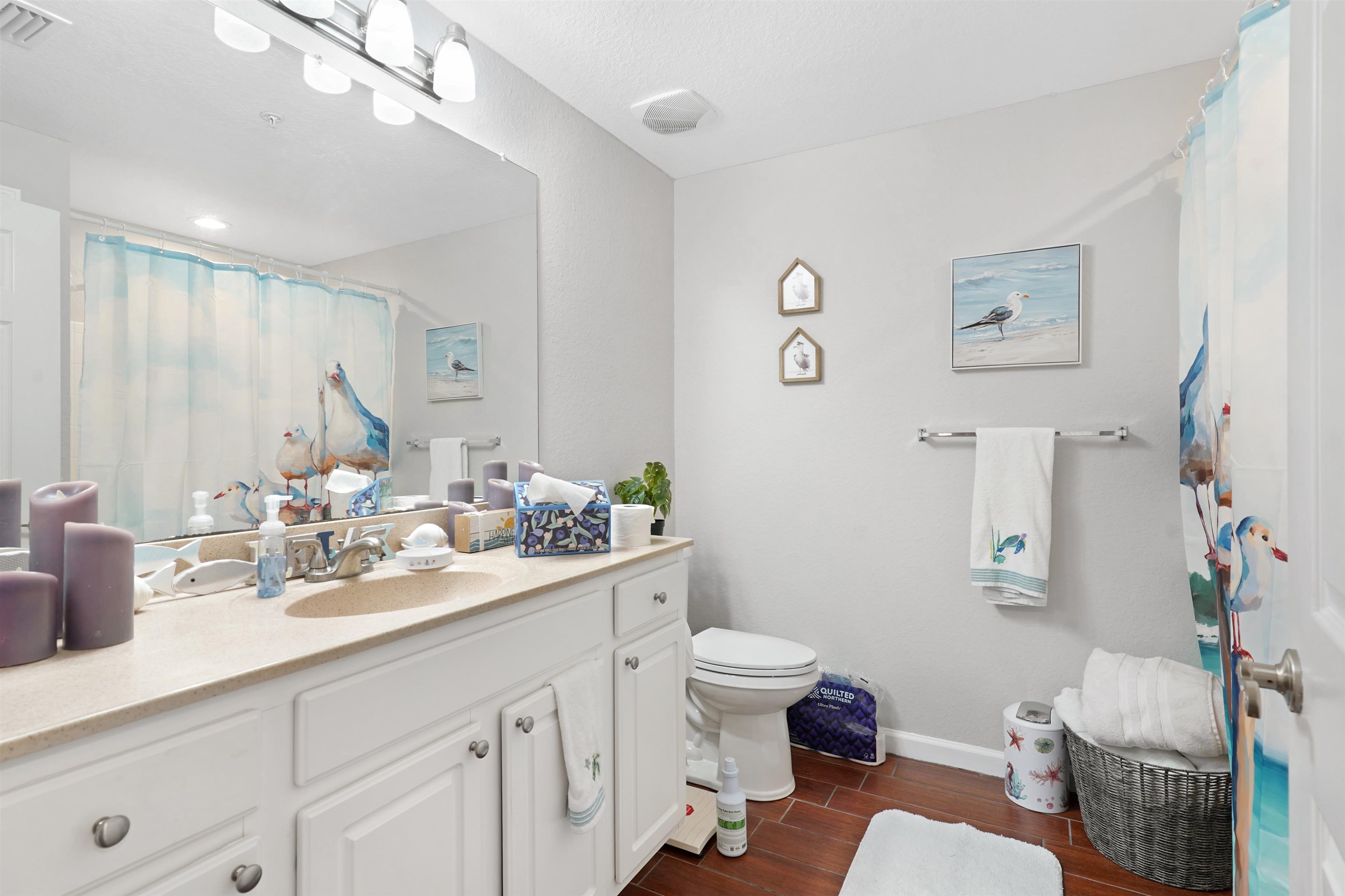 10075 Gate Parkway, Unit 203 Jacksonville, FL 32246 - Photo 20 of 34 Full bathroom featuring vanity, wood finish floors, and a shower with shower curtain