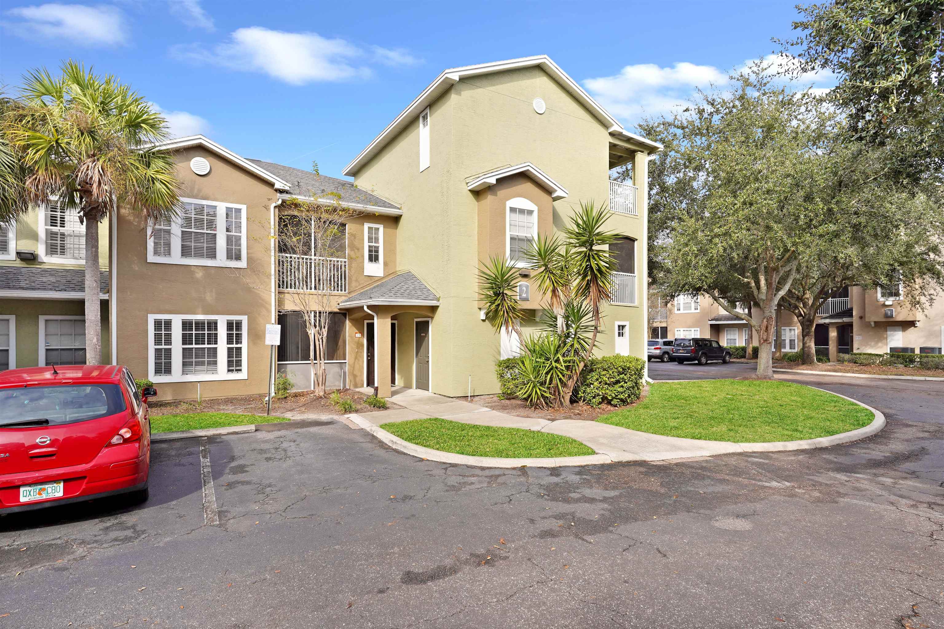 10075 Gate Parkway, Unit 203 Jacksonville, FL 32246 - Photo 3 of 34 a front view of a house with a garden