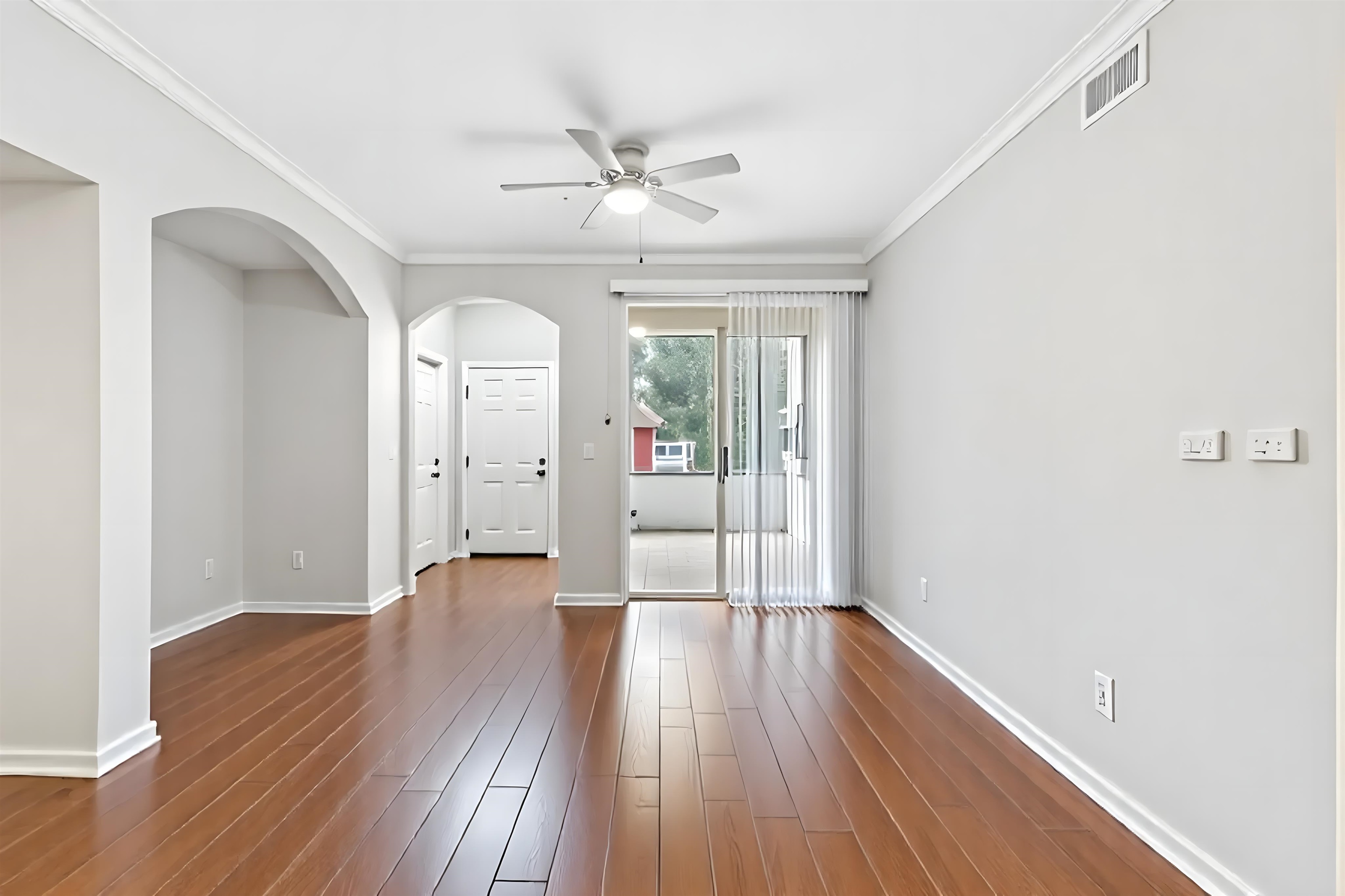 10075 Gate Parkway, Unit 203 Jacksonville, FL 32246 - Photo 5 of 34 wooden floor in an empty room with a window