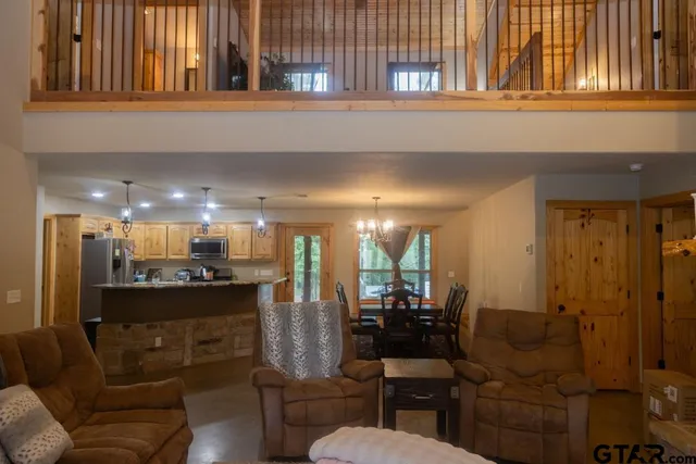 a kitchen with a dining table chairs sink and a mirror