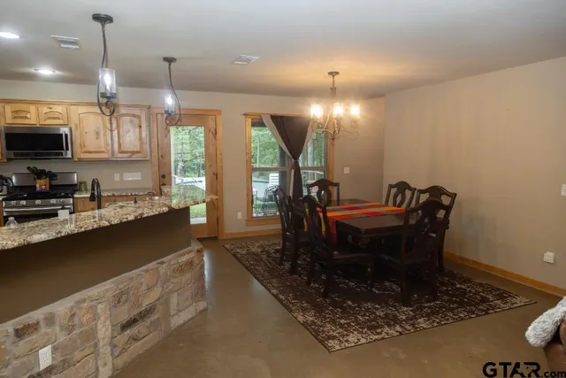 a living room with furniture and a view of bathroom