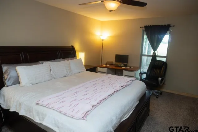 a bedroom with a bed and a fireplace