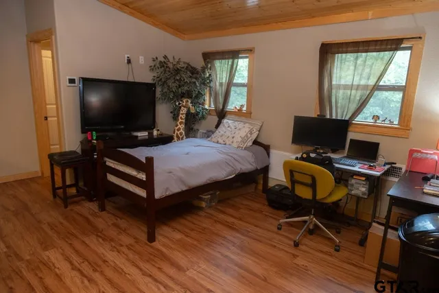a bedroom with furniture and a window