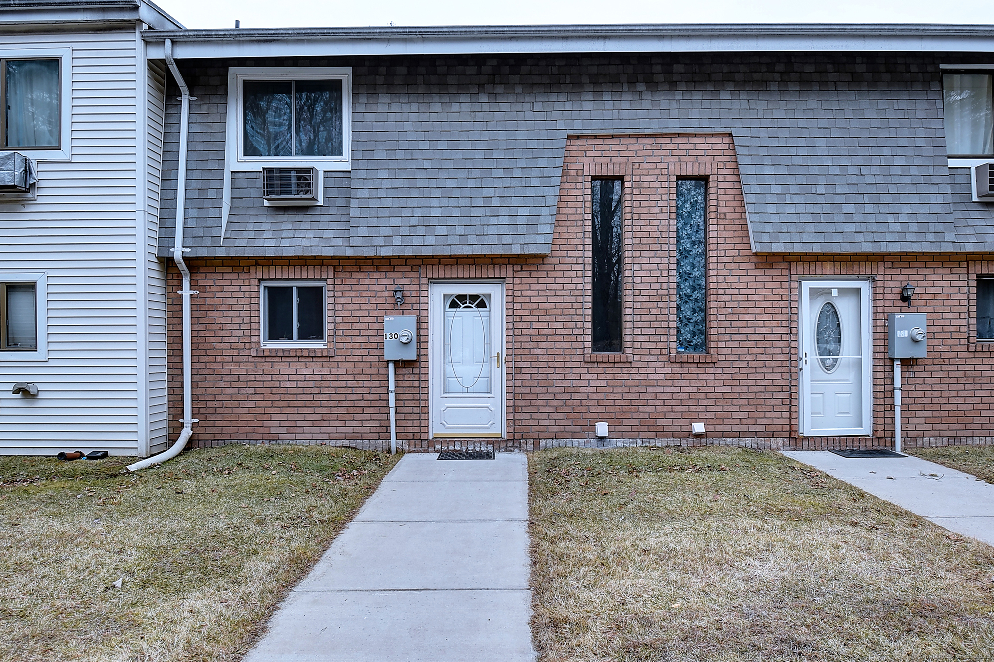 a front view of a house with a garden