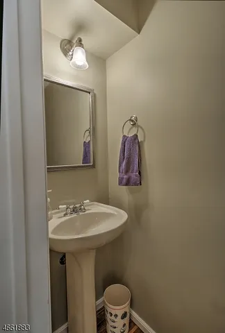 a bathroom with a sink mirror and toilet
