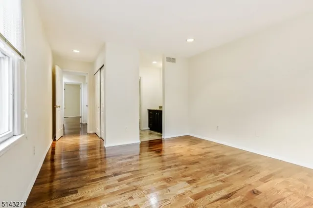 a view of a livingroom with wooden floor and staircase