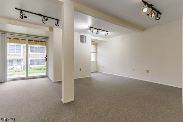 a view of a big room with windows and chandelier