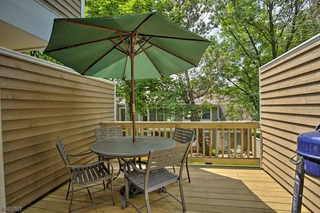 a view of balcony with furniture and umbrella